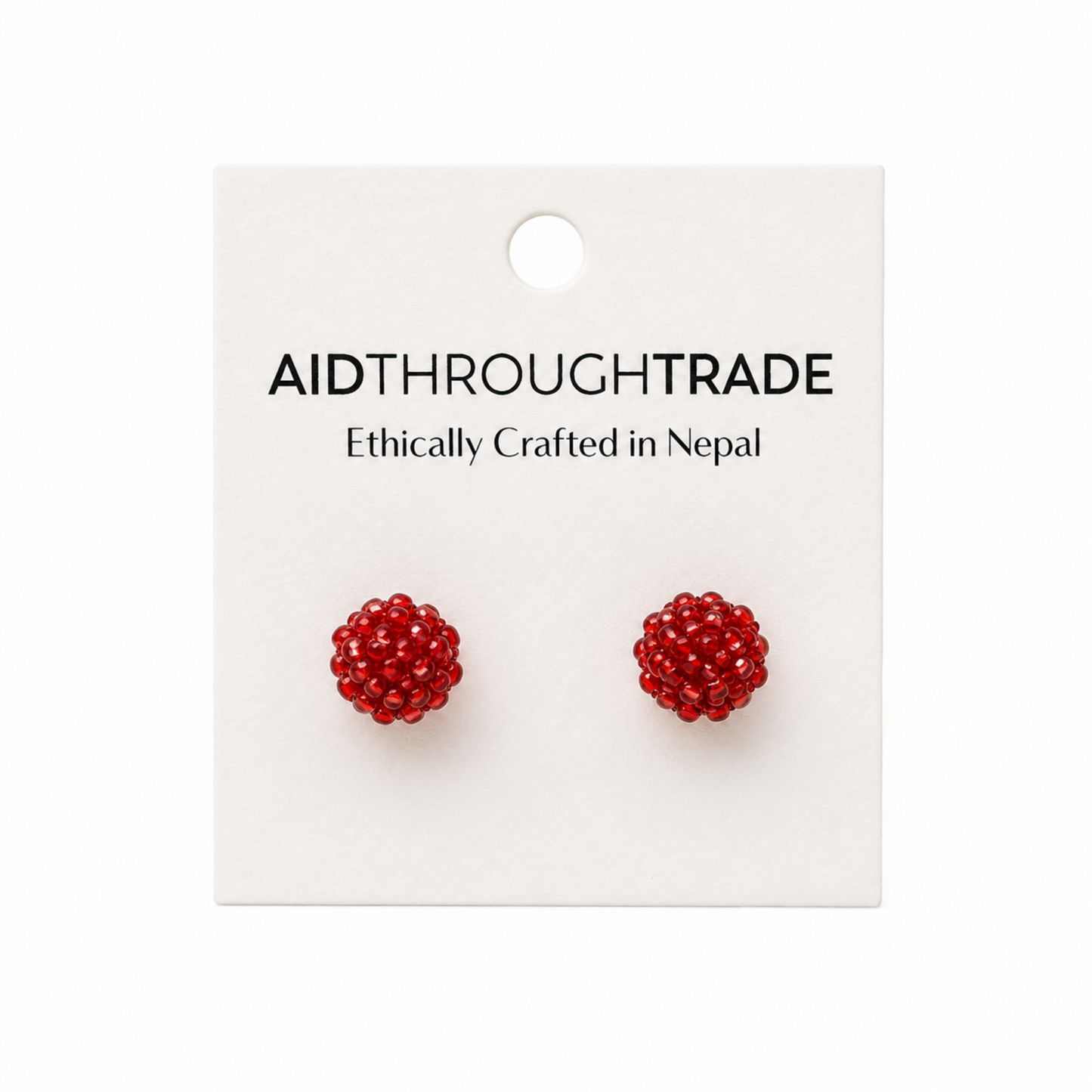 Red beaded earrings on a 'Aid Through Trade' branded card.