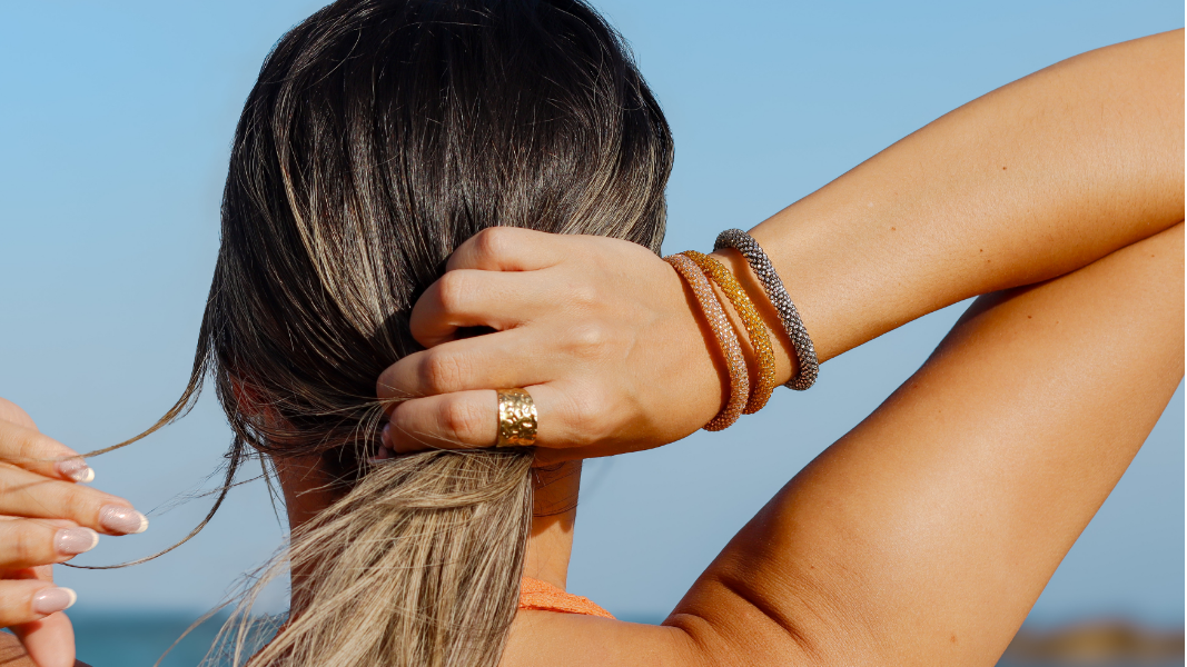 Woman with braided hair against a clear blue sky